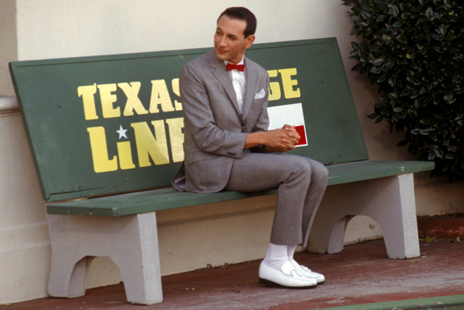 Full shot of Pee-Wee Herman as Himself, sitting on bench.