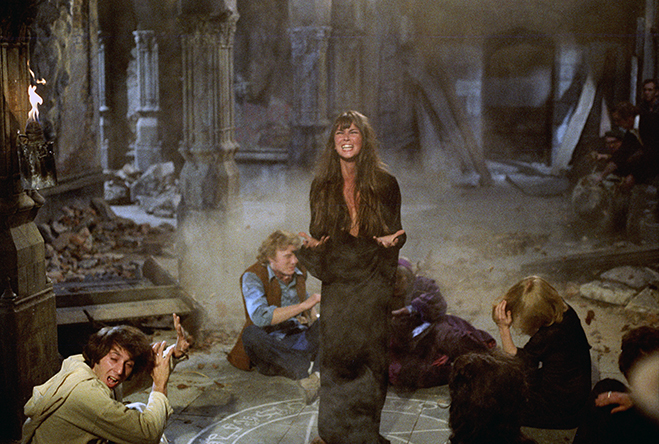 Screaming Caroline Munro as Laura standing in devil's circle