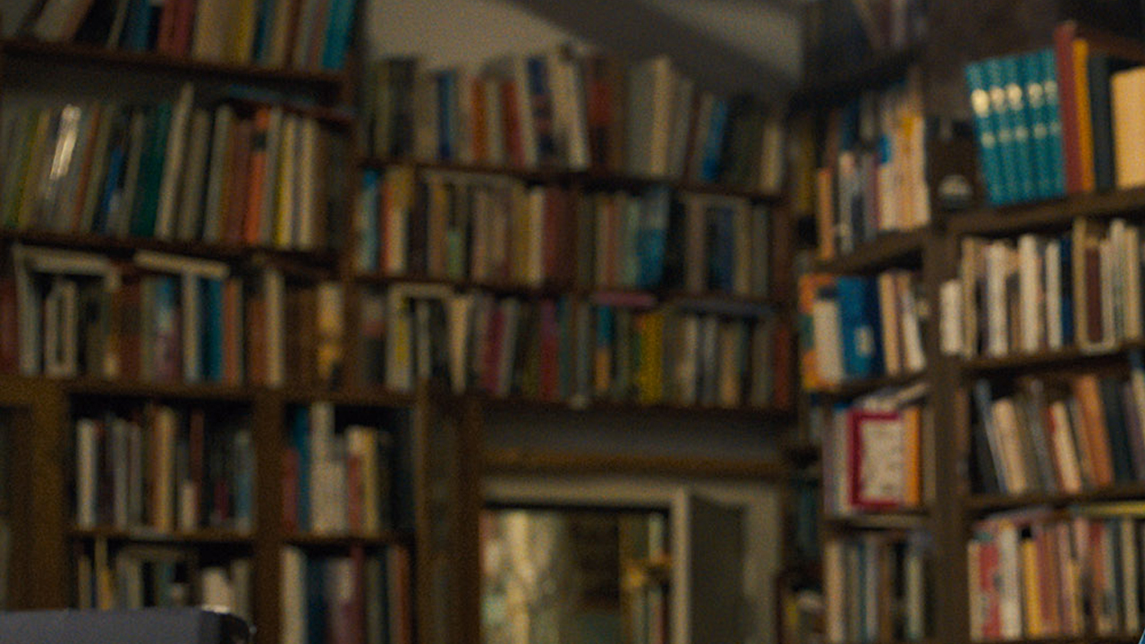 Piles of books on bookshelves